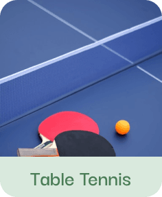 Table tennis paddles and ball on blue table surface